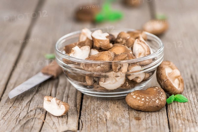 Shiitake mushrooms on a vintage background as detailed close-up shot, selective focus