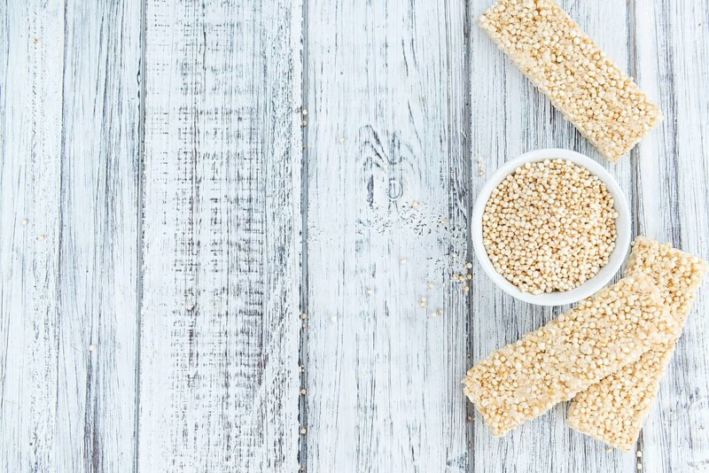 Fresh made Quinoa Bars (selective focus, close-up shot) on an old wooden table