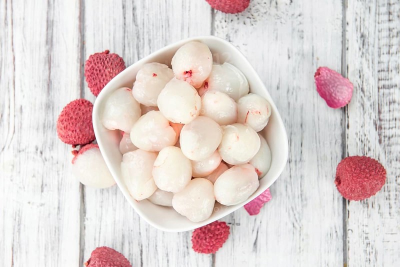 Lychees on a vintage background as detailed close-up shot (selective focus)