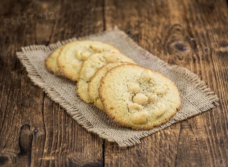 Wooden table with Cookies (detailed close-up shot, selective focus)