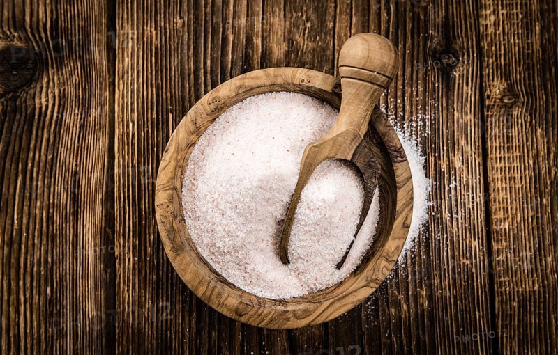 Himalayan Salt as high detailed close-up shot on a vintage wooden table (selective focus)