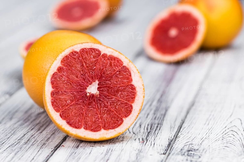 Grapefruits slices (selective focus) on a vintage background as detailed close-up shot