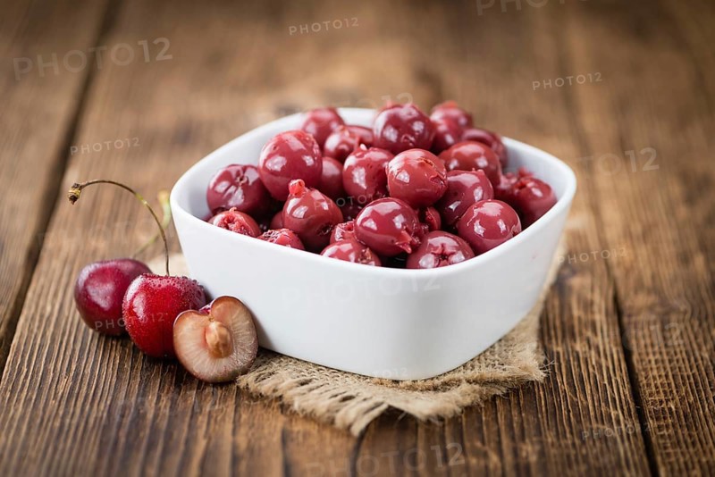 Preserved Cherries on a vintage background as detailed close-up shot, selective focus