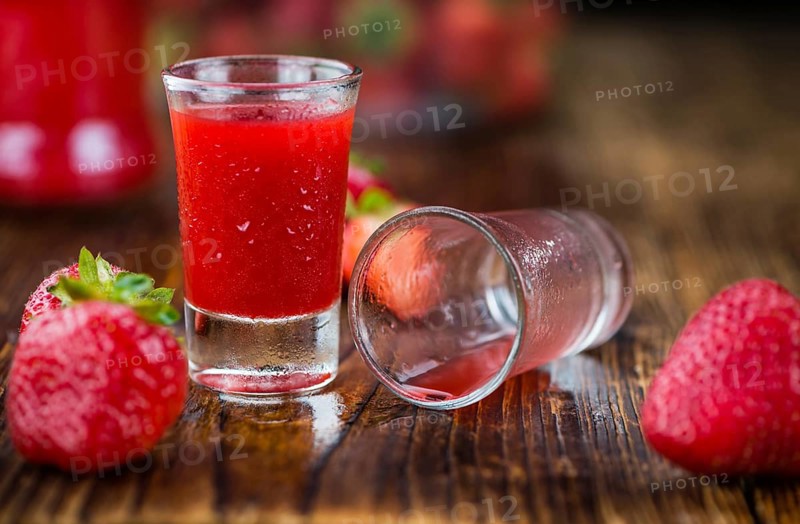 Some homemade Strawberry liqueur as detailed close-up shot, selective focus