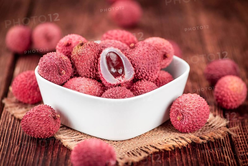 Lychees on a vintage background as detailed close-up shot (selective focus)