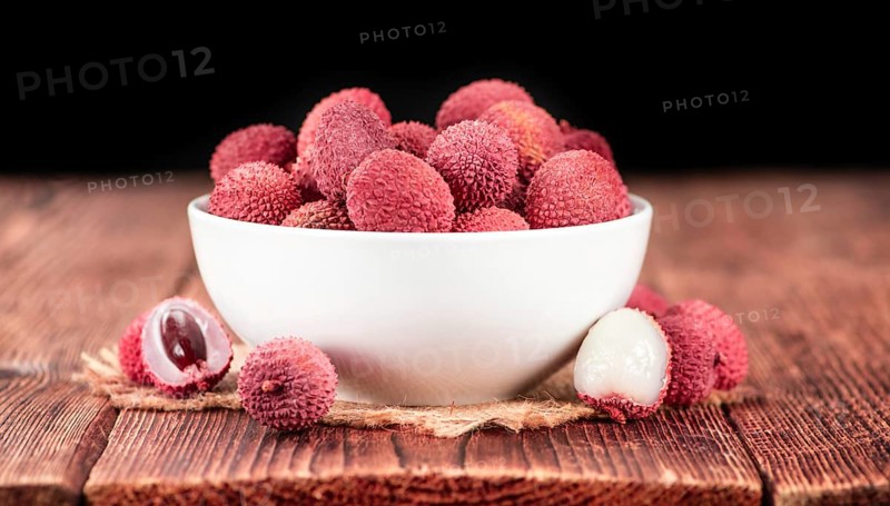 Lychees on a vintage background as detailed close-up shot (selective focus)