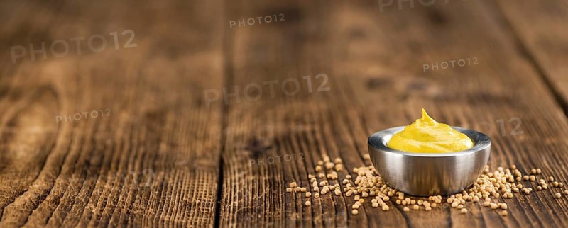 Mustard on a vintage background as detailed close-up shot (selective focus)
