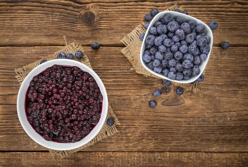 Preserved Blueberries on a vintage background as detailed close-up shot, selective focus