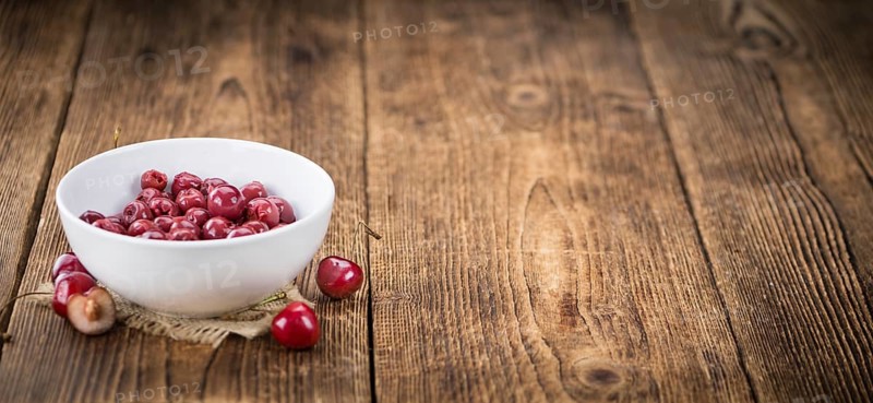 Preserved Cherries on a vintage background as detailed close-up shot, selective focus