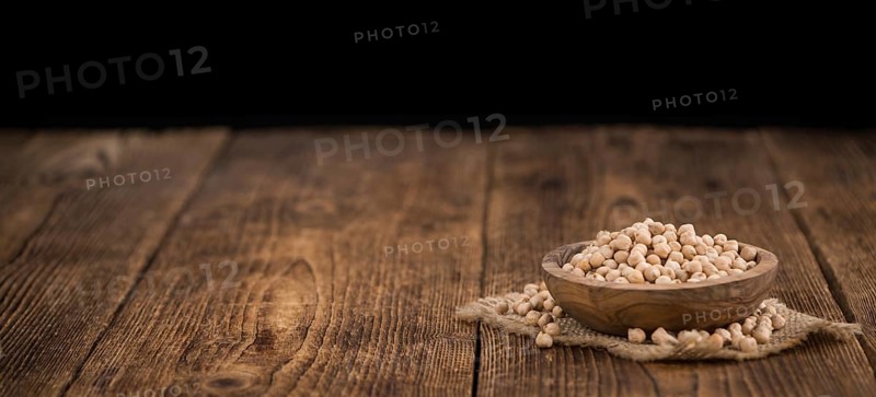 Chickpeas on a vintage background as detailed close-up shot, selective focus