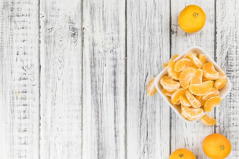 Raw Tangerine pieces (close-up shot) on vintage background