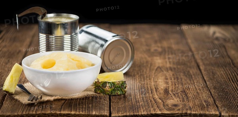 Preserved Pineapple Rings on a vintage background as detailed close-up shot, selective focus