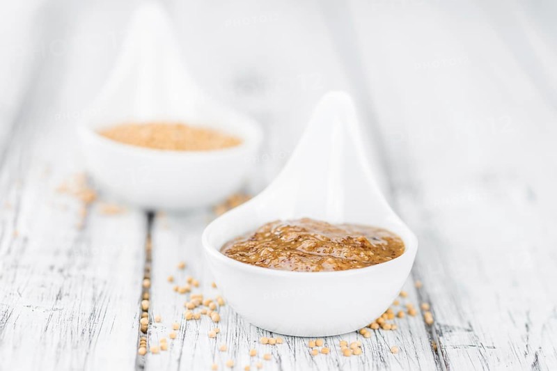 Fresh made German Cuisine (sweet Mustard) on a vintage background (close-up shot)