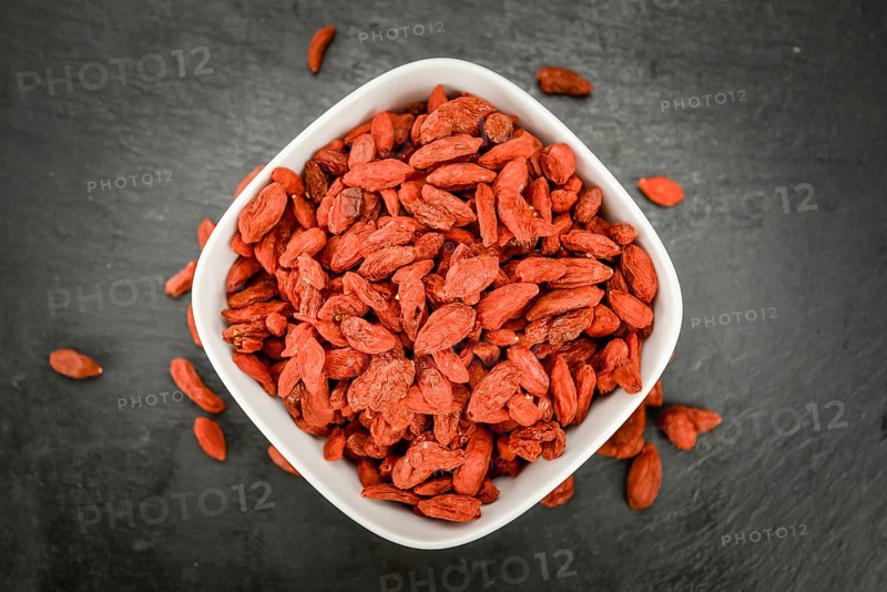 Some Dried Goji Berries on a slate slab (close-up shot, selective focus)