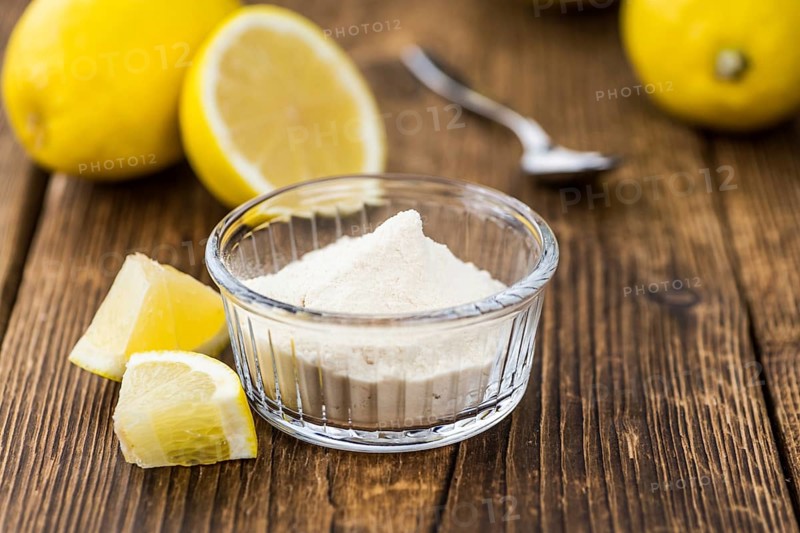 Wooden table with Lemon powder (detailed close-up shot, selective focus)