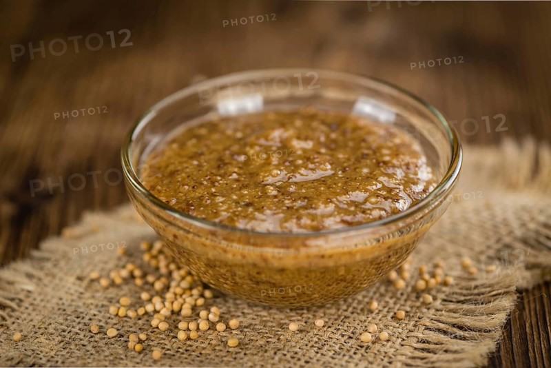 Sweet Mustard on a vintage background as detailed close-up shot (selective focus)