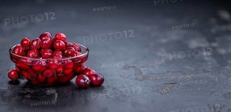 Healthy Canned Cranberries on a vintage slate slab (close-up shot, selective focus)