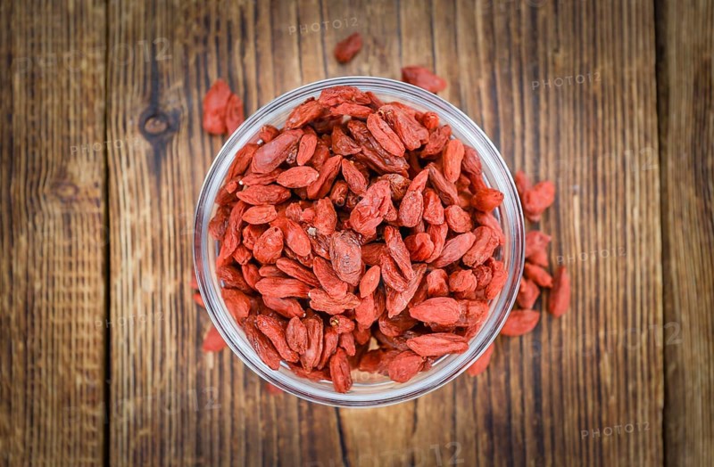 Fresh made Dried Goji Berries on a vintage background (close-up shot)