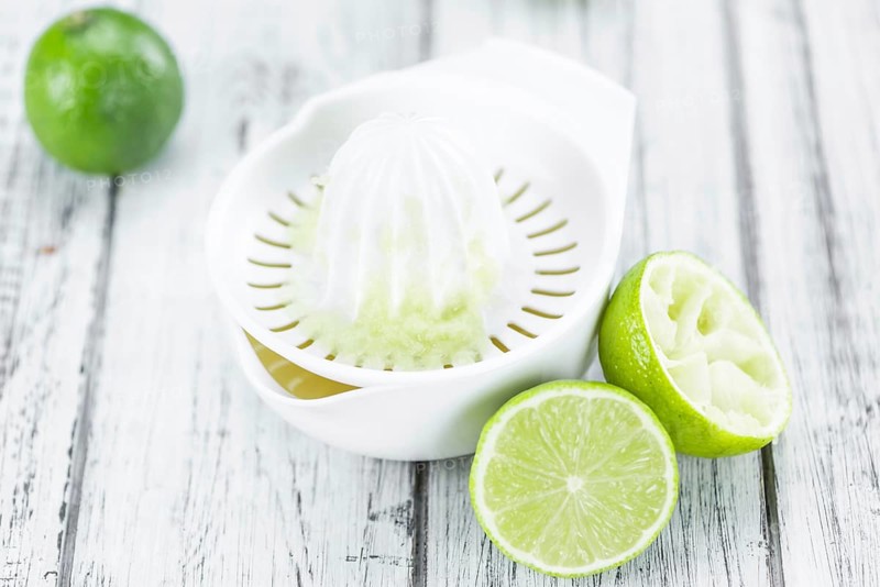 Lime Juice on a vintage background as detailed close-up shot (selective focus)