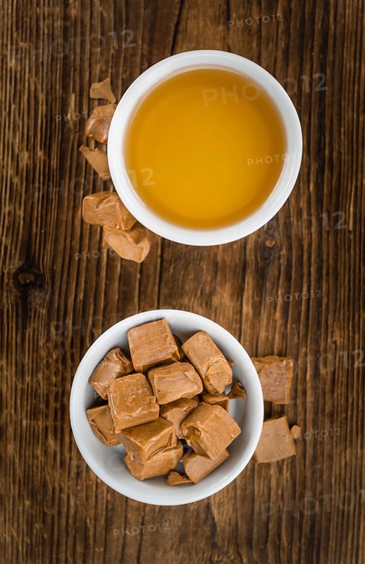 Caramel Sirup on a vintage background as detailed close-up shot (selective focus)