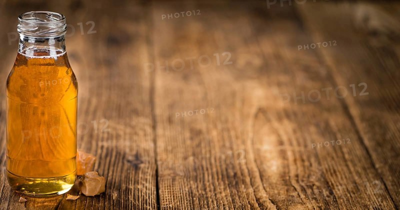 Caramel Sirup on a vintage background as detailed close-up shot (selective focus)