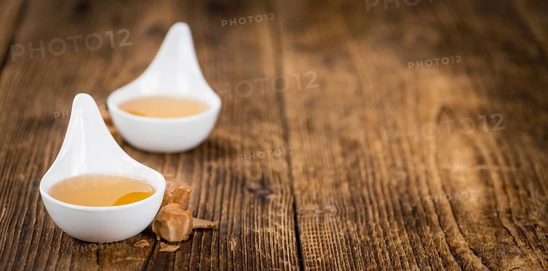 Caramel Sirup on a vintage background as detailed close-up shot (selective focus)