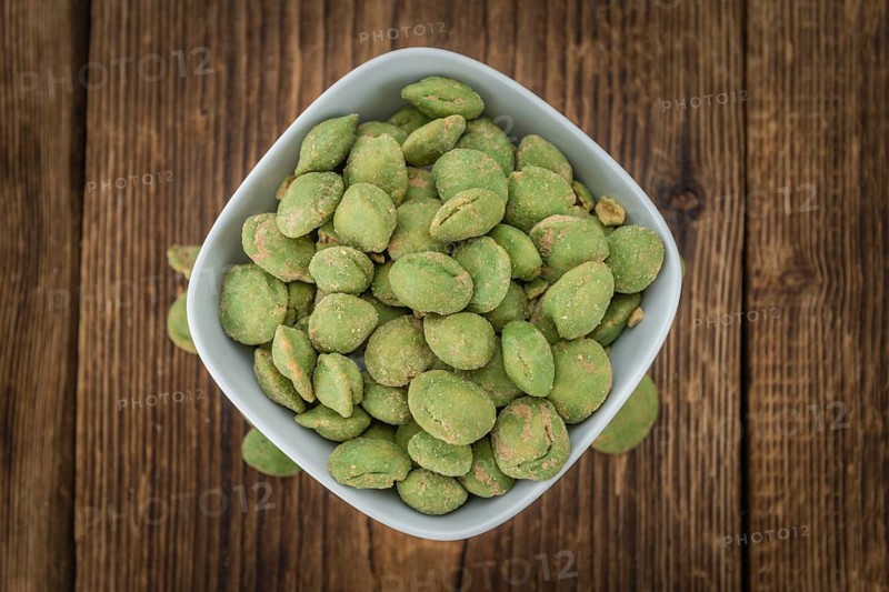 Wasabi Peanuts on a vintage background as detailed close-up shot (selective focus)
