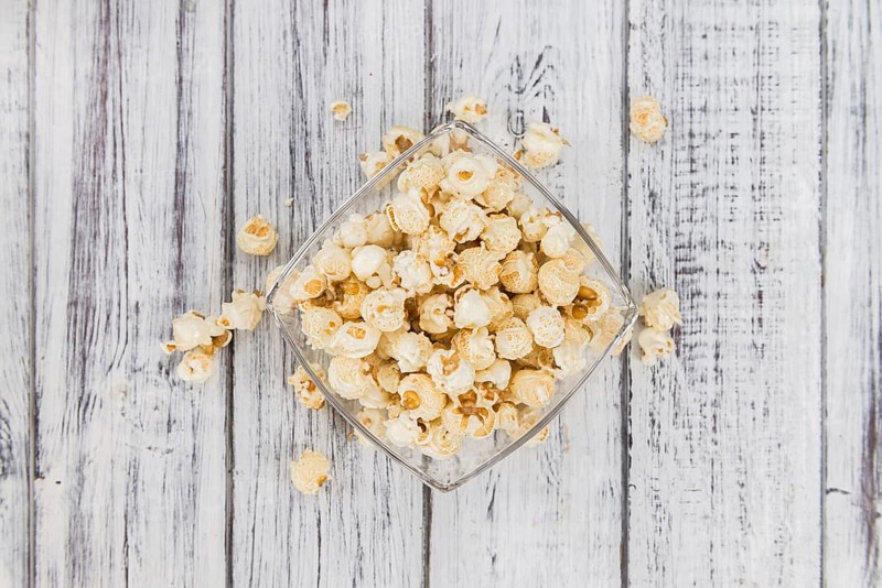 Fresh made Popcorn on a vintage background as detailed close-up shot