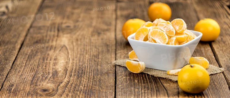 Raw Tangerine pieces (close-up shot) on vintage background