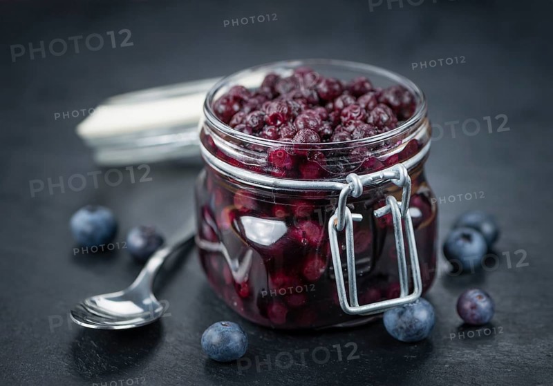 Preserved Blueberries on a vintage background as detailed close-up shot, selective focus