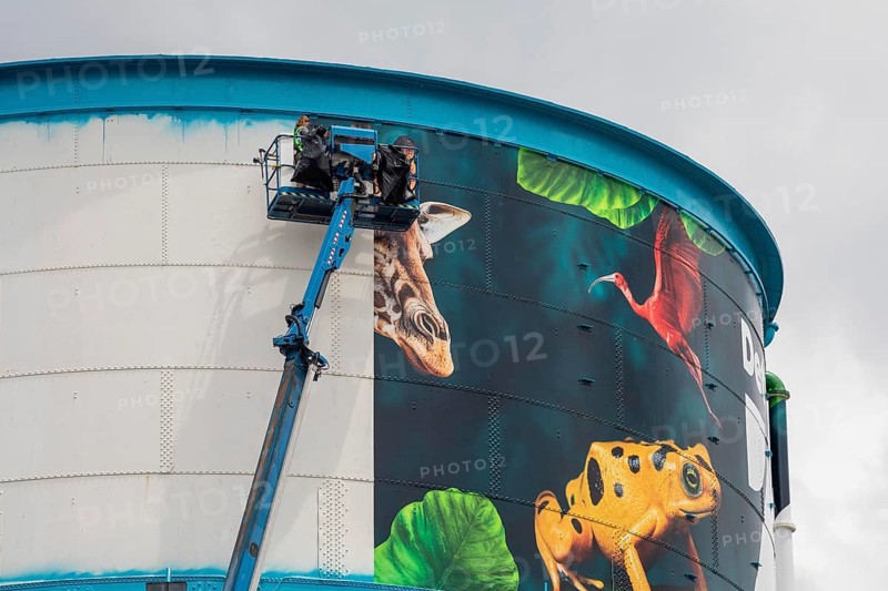 Detroit, Michigan, Workers wrap a new design on the water tower at the Detroit Zoo