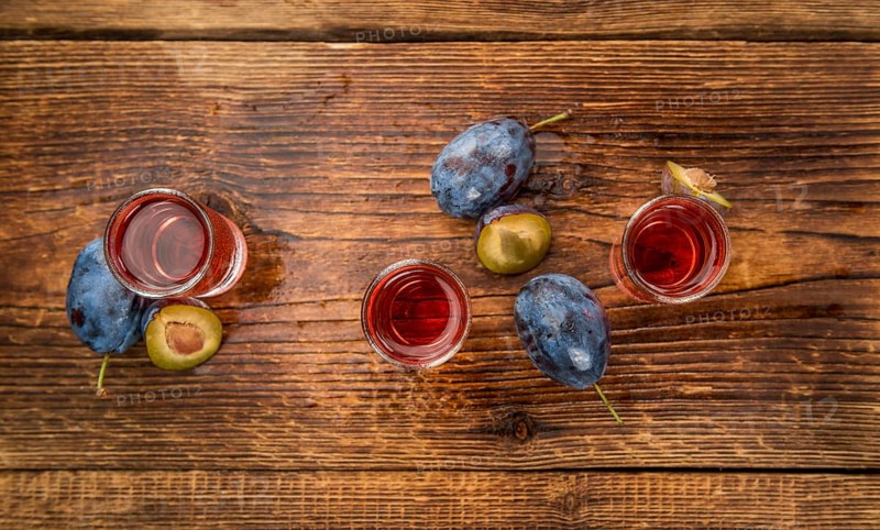 Fresh made Plum Liqueur on a vintage background as detailed close-up shot