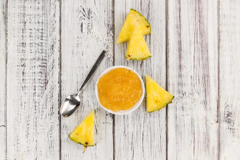 Fresh made Pineapple Jam on an old and rustic wooden table, selective focus, close-up shot