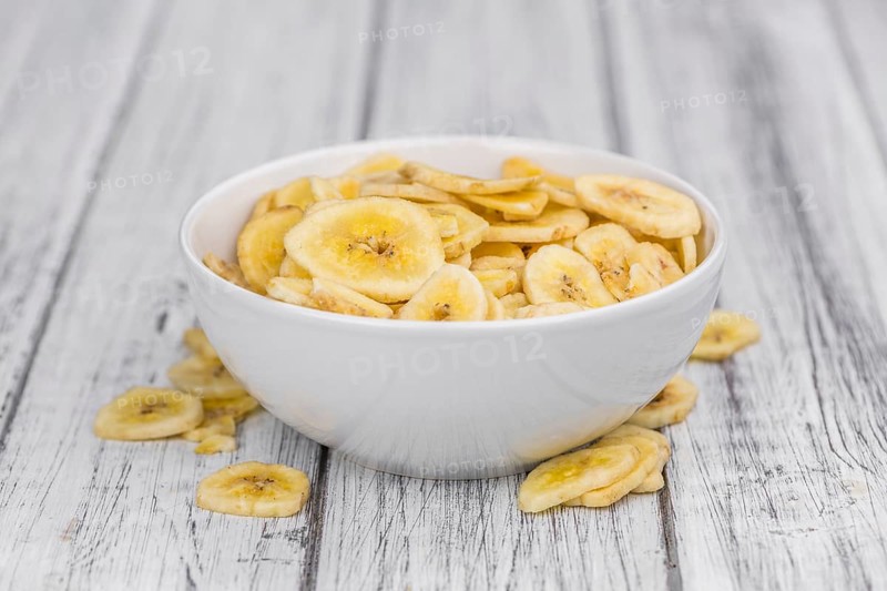 Portion of fresh Dried Banana Chips close-up shot, selective focus