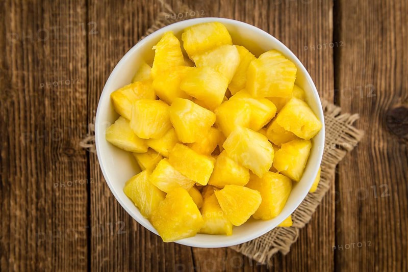 Fresh made Pineapple (sliced) on a vintage background as detailed close-up shot