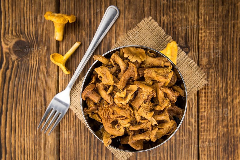 Canned chanterelles on a vintage background as detailed close-up shot, selective focus