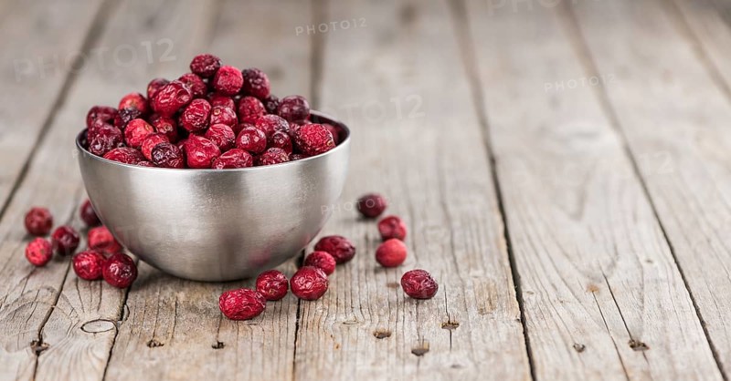 Dried Cranberries on an old wooden table (selective focus)