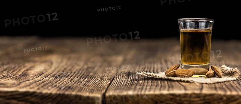 Amaretto on an old wooden table (selective focus)