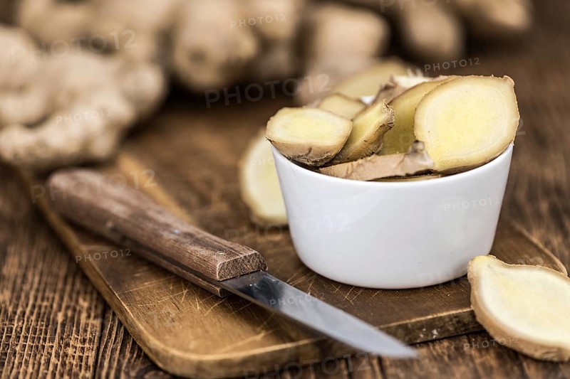 Healthy Raw Ginger on a wooden table as detailed close-up shot (selective focus)