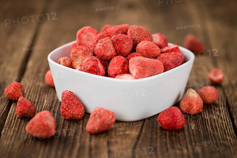 Dried Strawberries on rustic wooden background as close-up shot