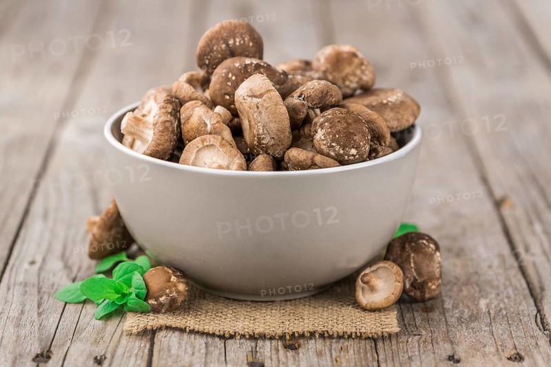 Portion of fresh Shiitake mushrooms close-up shot, selective focus