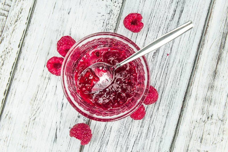 Fresh made Raspberry Jam on a vintage background as detailed close-up shot