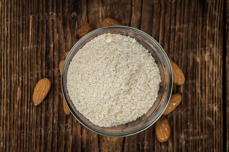 Wooden table with Almond Flour (detailed close-up shot, selective focus)