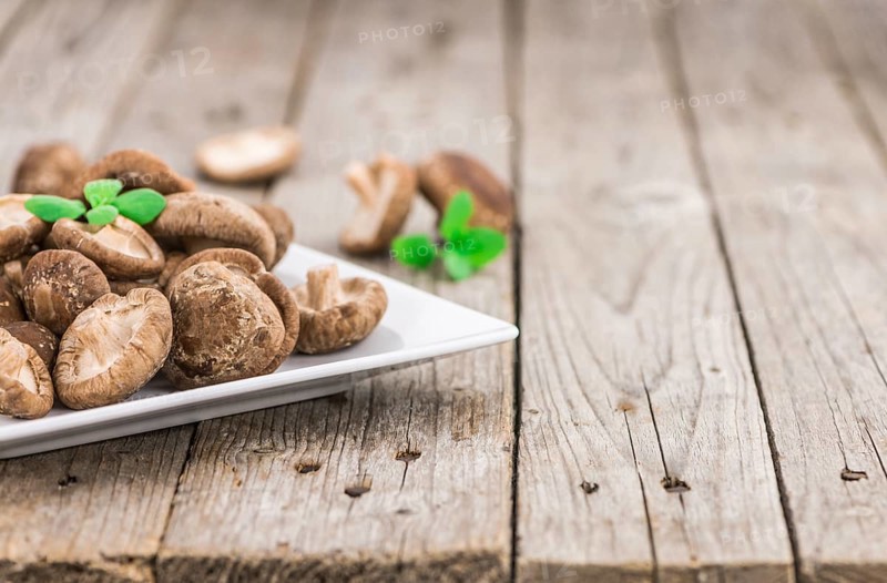 Shiitake mushrooms on a vintage background as detailed close-up shot, selective focus