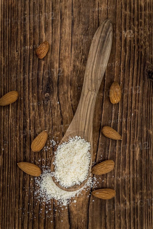 Portion of fresh Powdered Almonds on an old wooden table