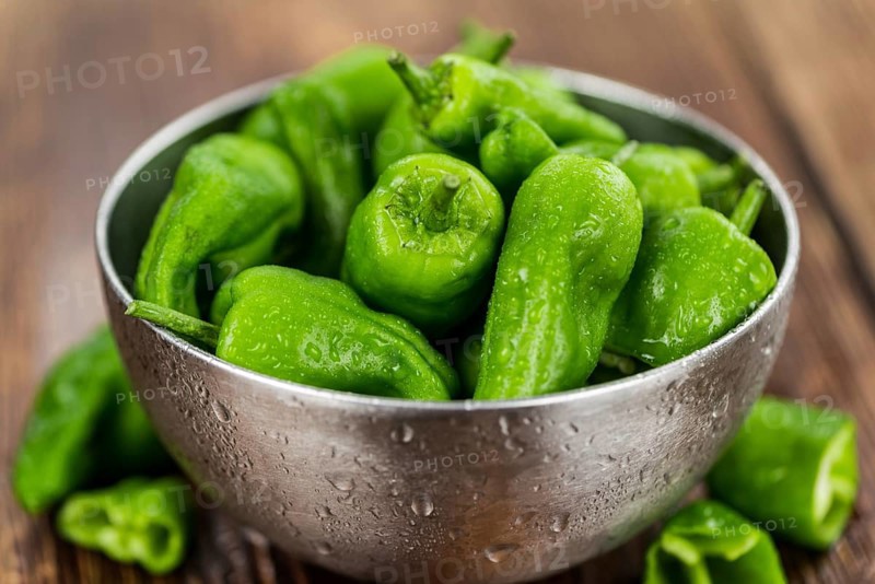 Raw Pimientos on a vintage background as detailed close-up shot, selective focus