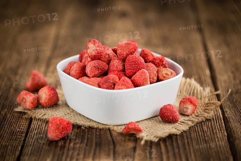 Dried Strawberries on rustic wooden background as close-up shot