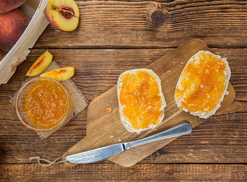 Portion of fresh Peach Jam close-up shot, selective focus