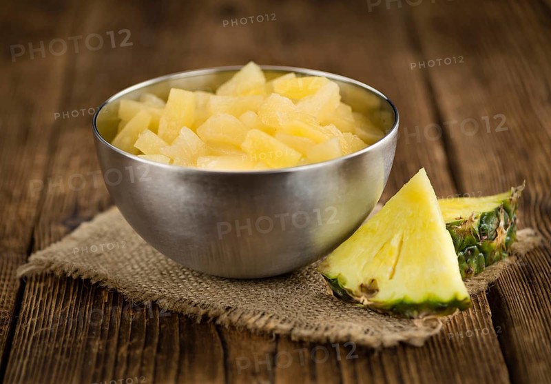 Preserved Pineapple pieces on a vintage background as detailed close-up shot, selective focus