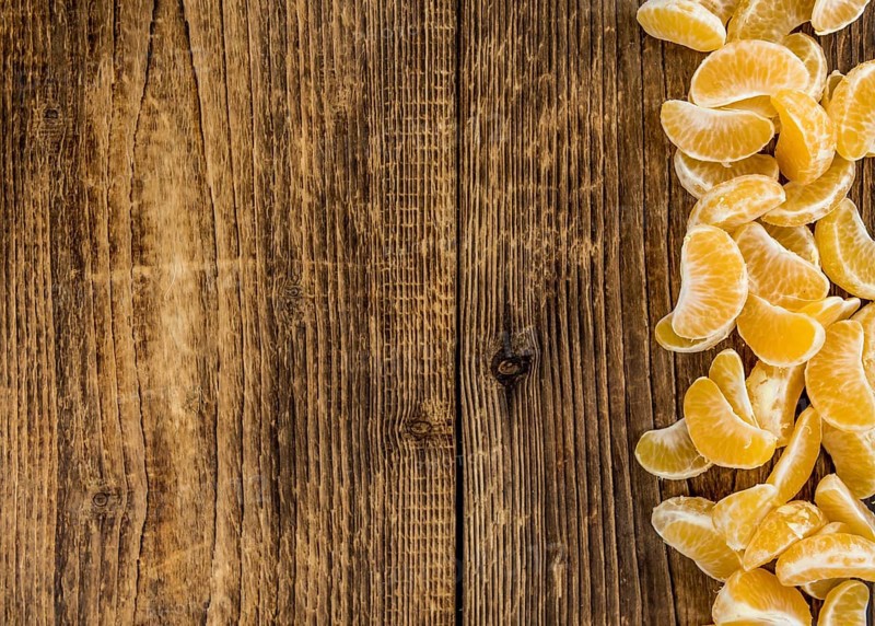 Fresh Tangerine pieces (selective focus) on a vintage background